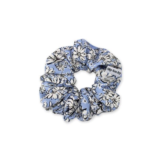 Blue rayon fabric hair scrunchie with white florals outlined in black with a inky illustrated style, soft and comfortable, great for everyday wear