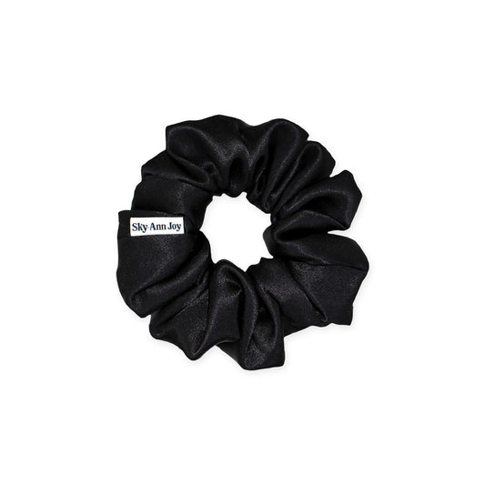 Black satin hair scrunchie made from polyester fabric, luxurious and shiny, perfect for adding a touch of elegance to formal outfits