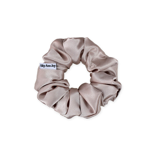 Blush satin hair scrunchie made from polyester fabric, luxurious and shiny, perfect for adding a touch of elegance to formal outfits