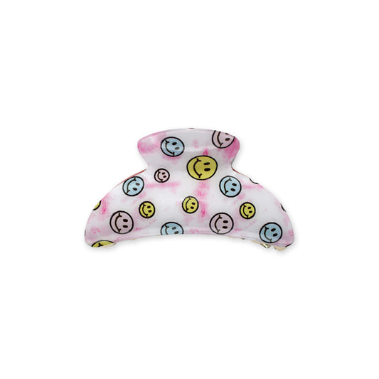 Rounded hair claw with blue, yellow and pink smiley faces on a tie dye background, fun and stylish, perfect for tweens and teens